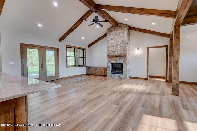245 Pond Dr, Victor, ID 83455 - unfurnished living room featuring french doors, ceiling fan, light wood-style floors, a fireplace, and recessed lighting