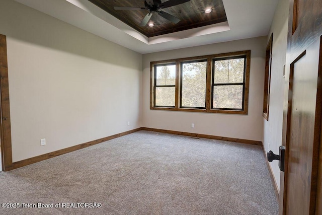 245 Pond Dr, Victor, ID 83455 - unfurnished room with a tray ceiling, carpet, a ceiling fan, and wooden ceiling
