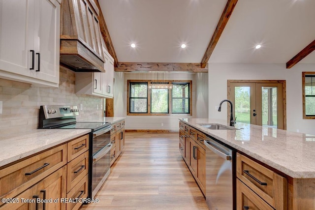 245 Pond Dr, Victor, ID 83455 - kitchen featuring appliances with stainless steel finishes, custom range hood, beamed ceiling, light wood-style floors, and french doors