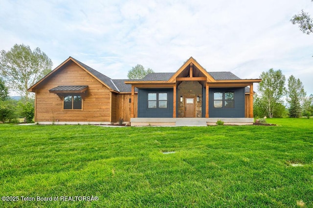 245 Pond Dr, Victor, ID 83455 - view of front facade featuring a front yard and a shingled roof