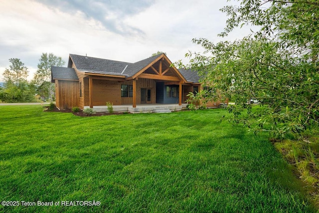 245 Pond Dr, Victor, ID 83455 - rear view of house with a porch, a lawn, and a shingled roof