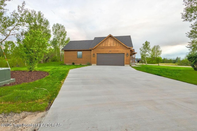 245 Pond Dr, Victor, ID 83455 - view of front of house with concrete driveway, a front yard, and an attached garage