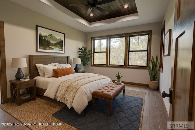 245 Pond Dr, Victor, ID 83455 - bedroom with hardwood / wood-style flooring, a tray ceiling, a ceiling fan, and recessed lighting