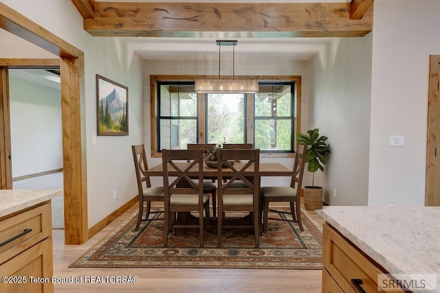 245 Pond Dr, Victor, ID 83455 - dining room featuring light wood finished floors and beamed ceiling