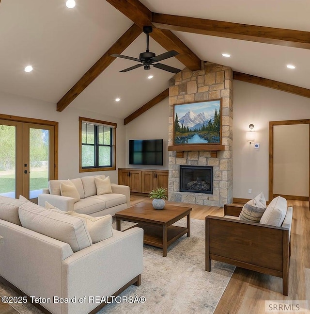 245 Pond Dr, Victor, ID 83455 - living room featuring light wood-style floors, ceiling fan, french doors, a stone fireplace, and recessed lighting