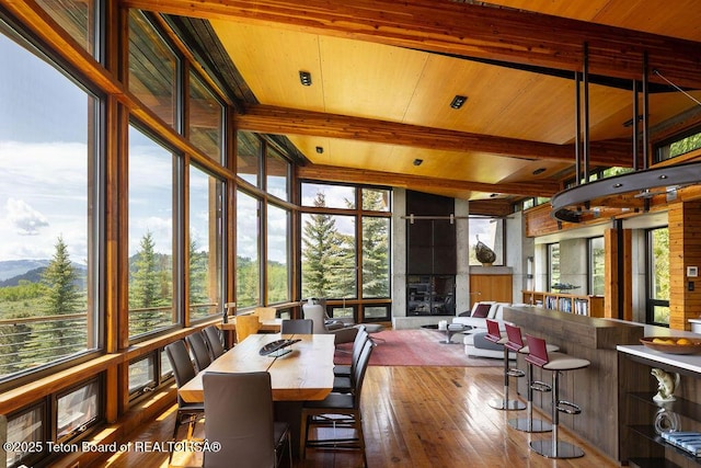1955 W Bohnetts Rd, Jackson, WY 83001 - dining area featuring a wooden ceiling with exposed beams, wood-type flooring, plenty of natural light, and a mountain view