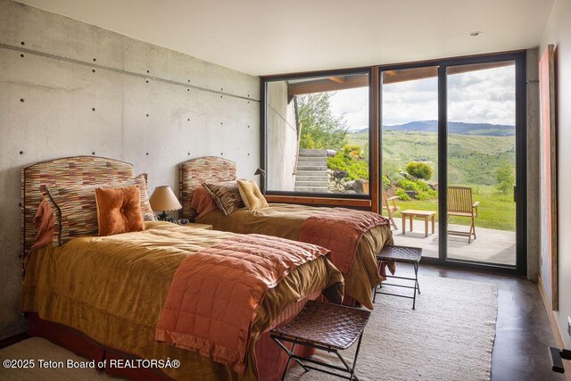 1955 W Bohnetts Rd, Jackson, WY 83001 - bedroom featuring a wall of windows, access to exterior, and a mountain view