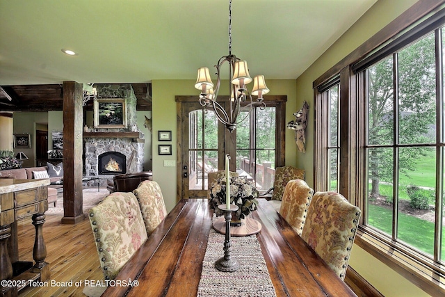 70 Hastings Dr, Victor, ID 83455 - dining room featuring a chandelier, hardwood / wood-style flooring, and a fireplace