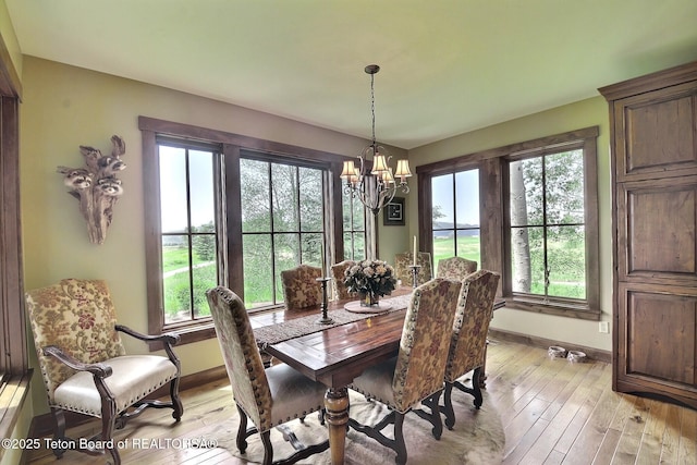70 Hastings Dr, Victor, ID 83455 - dining area with a chandelier, plenty of natural light, and light wood-style floors