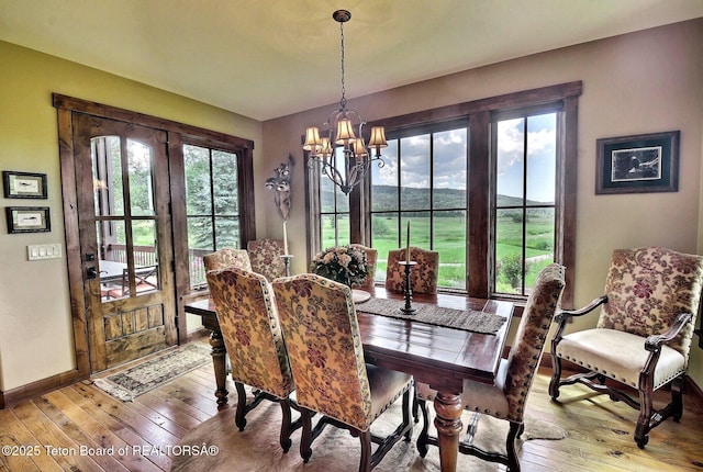 70 Hastings Dr, Victor, ID 83455 - dining space with a chandelier, healthy amount of natural light, and wood-type flooring