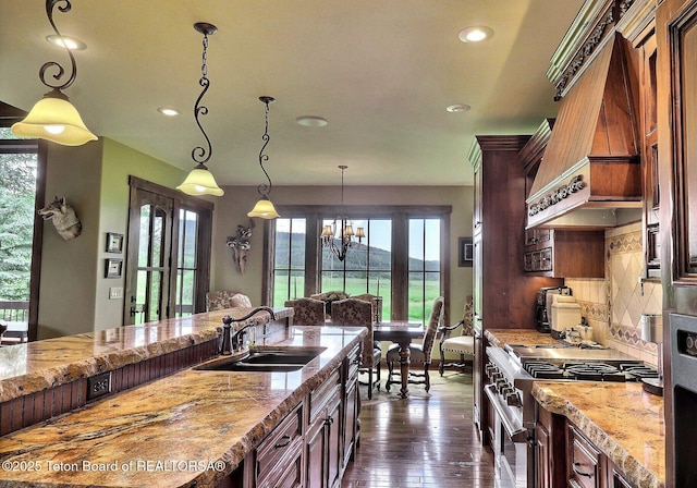 70 Hastings Dr, Victor, ID 83455 - kitchen featuring high end range, recessed lighting, custom range hood, dark wood-style flooring, and hanging light fixtures