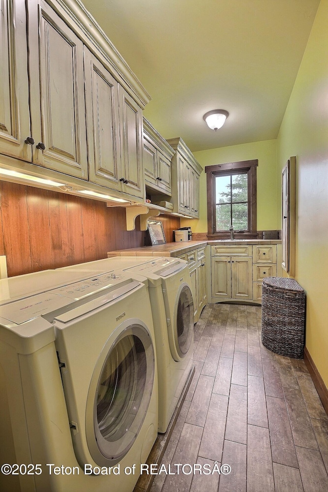 70 Hastings Dr, Victor, ID 83455 - laundry room featuring cabinet space, washer and dryer, and light wood-style floors
