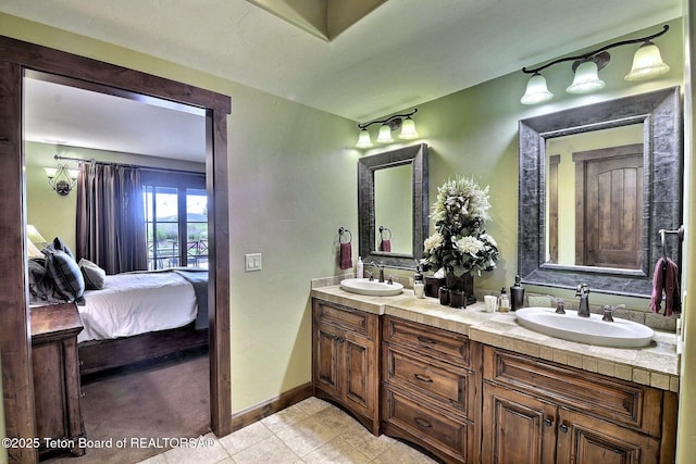 70 Hastings Dr, Victor, ID 83455 - full bathroom with double vanity, tile patterned flooring, and connected bathroom