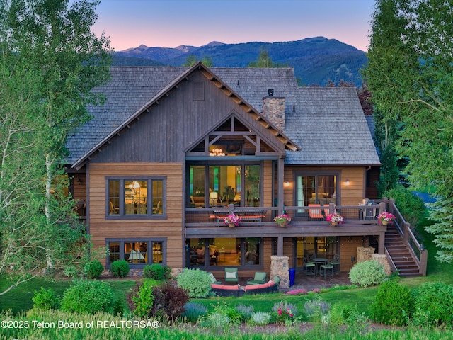 70 Hastings Dr, Victor, ID 83455 - back of house featuring stairway, a patio, a chimney, and a deck with mountain view