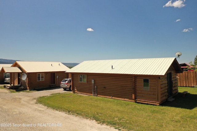 4760 W 500 W, Victor, ID 83455 - view of front of house with log siding, a metal roof, and dirt driveway