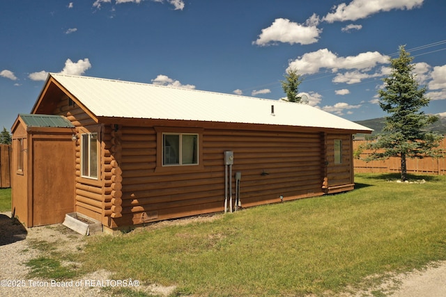 4760 W 500 W, Victor, ID 83455 - rear view of house with log siding, a metal roof, and an outbuilding