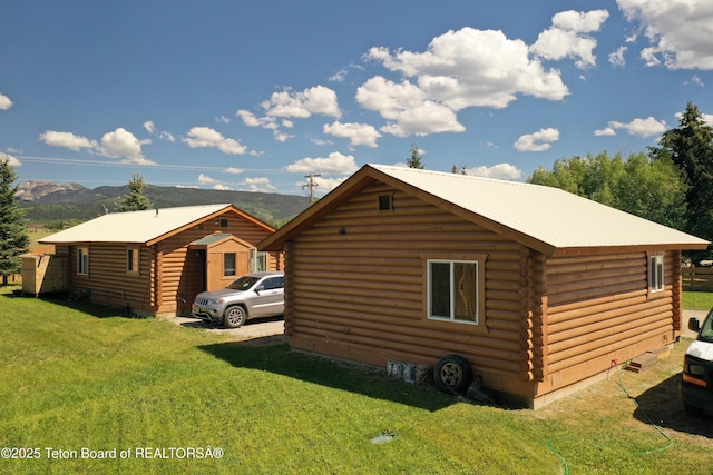 4760 W 500 W, Victor, ID 83455 - view of side of home with log exterior and a lawn