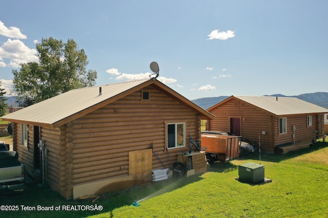 4760 W 500 W, Victor, ID 83455 - back of house featuring log exterior, a yard, a metal roof, and a jacuzzi
