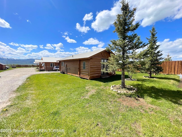 4760 W 500 W, Victor, ID 83455 - view of property exterior featuring log exterior, a metal roof, and driveway