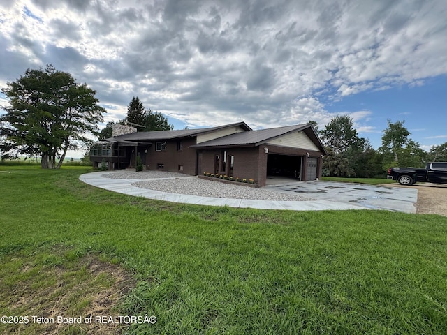 13280 N 3750 W, Felt, ID 83424 - view of home's exterior featuring a garage, a lawn, concrete driveway, a chimney, and brick siding