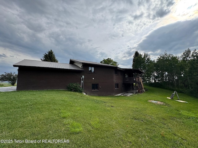 13280 N 3750 W, Felt, ID 83424 - view of property exterior featuring a yard, brick siding, and a wooden deck