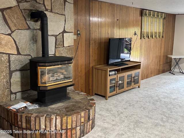 13280 N 3750 W, Felt, ID 83424 - living area with a wood stove, wood walls, and carpet floors