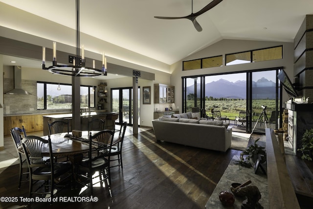 580 Moulton Loop Rd, Jackson, WY 83001 - dining space with a ceiling fan, healthy amount of natural light, a mountain view, dark wood-type flooring, and high vaulted ceiling