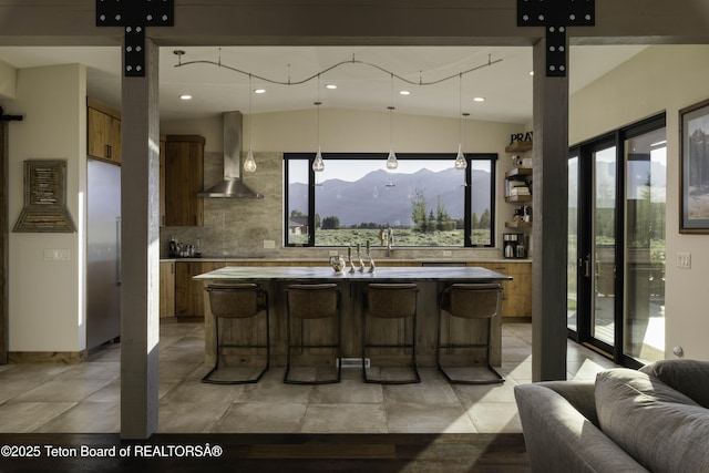 580 Moulton Loop Rd, Jackson, WY 83001 - kitchen with wall chimney range hood, plenty of natural light, modern cabinets, light countertops, and recessed lighting