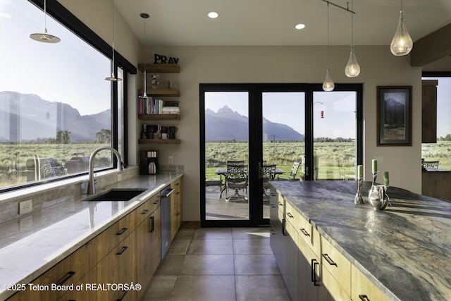 580 Moulton Loop Rd, Jackson, WY 83001 - kitchen featuring a mountain view, modern cabinets, light stone countertops, hanging light fixtures, and recessed lighting