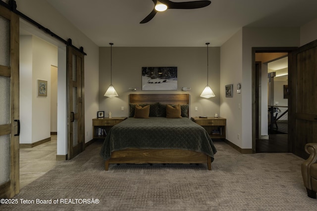 580 Moulton Loop Rd, Jackson, WY 83001 - carpeted bedroom featuring a barn door and ceiling fan