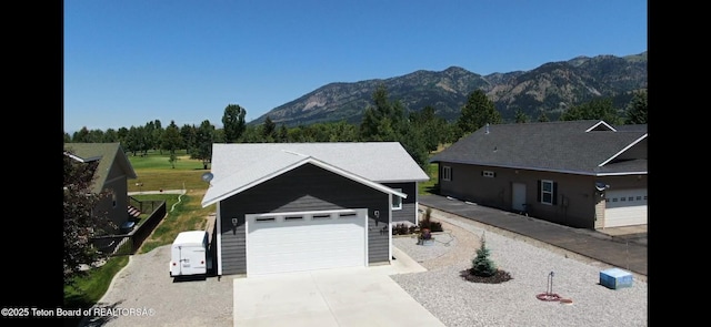 643 Country Club Way, Thayne, WY 83127 - ranch-style house featuring a mountain view, a garage, and driveway