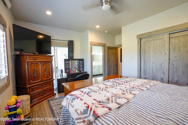 643 Country Club Way, Thayne, WY 83127 - bedroom with wood finished floors, multiple windows, recessed lighting, a closet, and ensuite bath