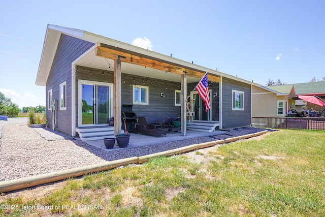 643 Country Club Way, Thayne, WY 83127 - rear view of house with entry steps and a patio area