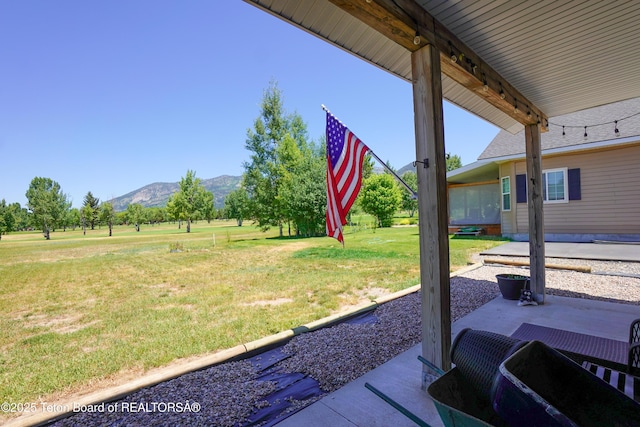 643 Country Club Way, Thayne, WY 83127 - view of green lawn featuring a mountain view, a patio area, and a rural view