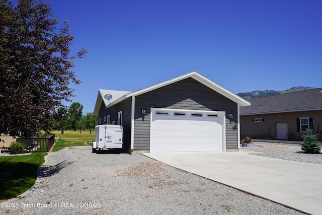 643 Country Club Way, Thayne, WY 83127 - view of front of house with driveway, a mountain view, and a garage