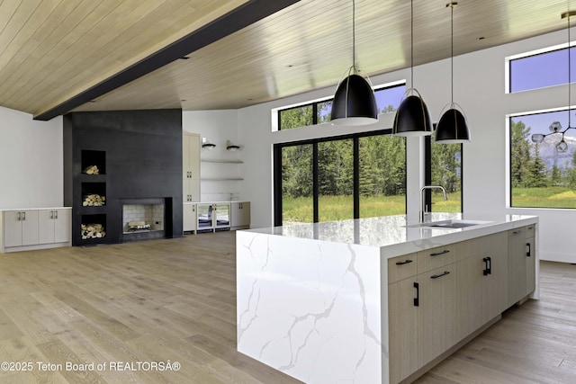 175 Huckleberry Dr, Jackson, WY 83001 - kitchen with pendant lighting, light wood finished floors, plenty of natural light, a towering ceiling, and a wooden ceiling with exposed beams