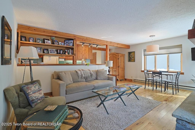 4435 Berry Dr Unit 3611, Wilson, WY 83014 - living room with a textured ceiling, a baseboard heating unit, and hardwood / wood-style floors
