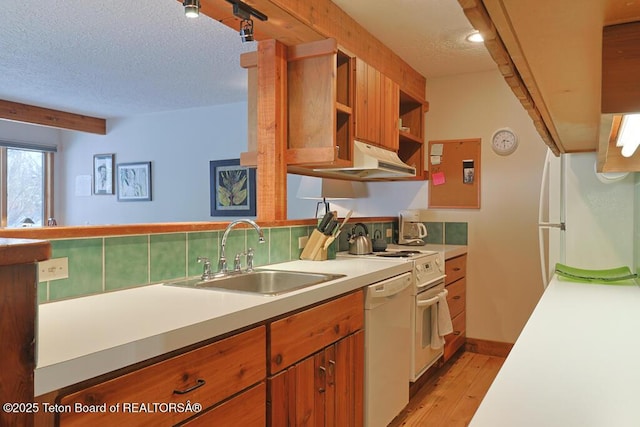 4435 Berry Dr Unit 3611, Wilson, WY 83014 - kitchen with white appliances, light wood-style flooring, a textured ceiling, light countertops, and under cabinet range hood