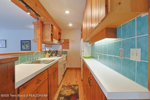 4435 Berry Dr Unit 3611, Wilson, WY 83014 - kitchen with a textured ceiling, light wood-type flooring, backsplash, dishwasher, and light countertops
