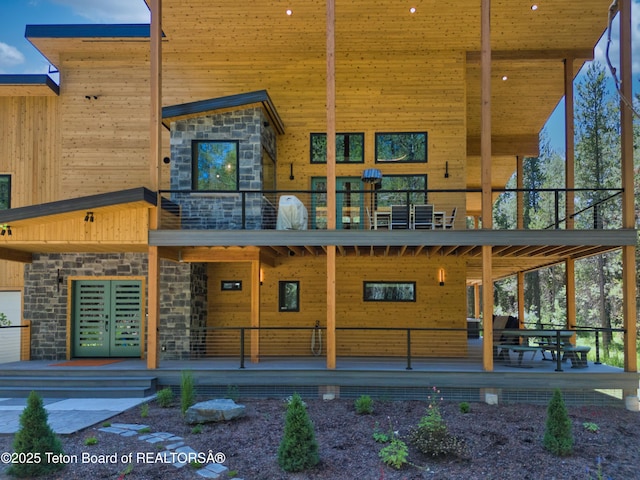 4327 Bridger Rdg, Ashton, ID 83420 - rear view of house featuring stone siding and a balcony