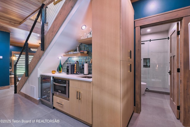 4327 Bridger Rdg, Ashton, ID 83420 - indoor bar with stainless steel oven, stairway, wine cooler, and decorative backsplash