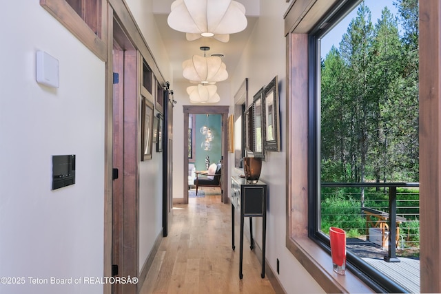 4327 Bridger Rdg, Ashton, ID 83420 - corridor featuring light wood finished floors and a chandelier
