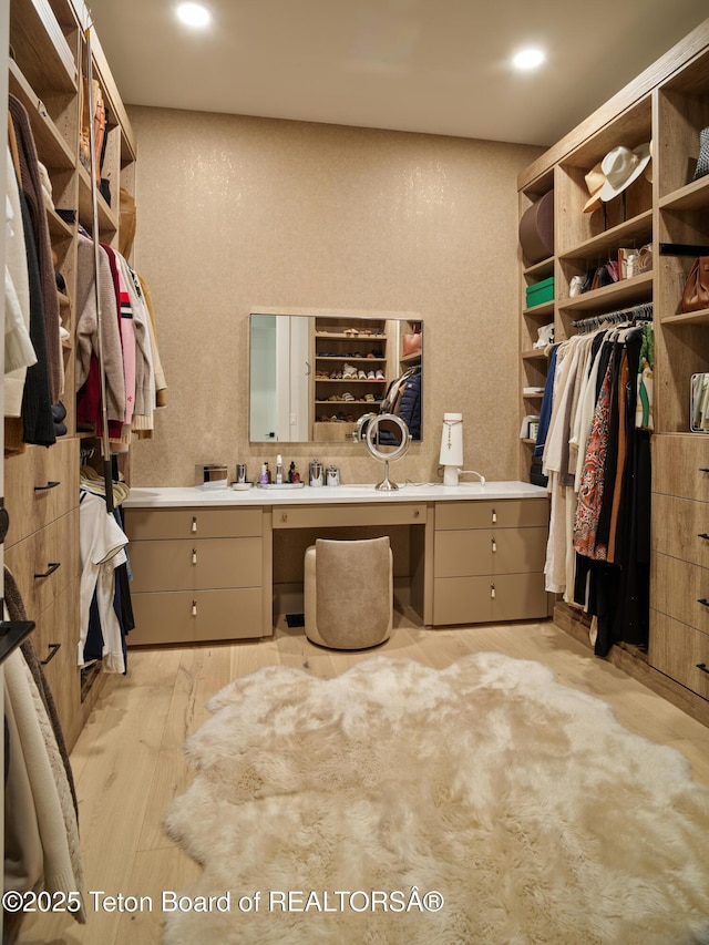 3220 N Teton Pines Dr, Wilson, WY 83014 - walk in closet with built in study area and light wood-type flooring