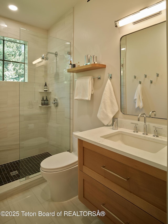 3220 N Teton Pines Dr, Wilson, WY 83014 - bathroom with vanity, a tile shower, tile patterned flooring, and recessed lighting