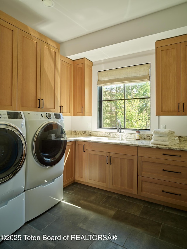 3220 N Teton Pines Dr, Wilson, WY 83014 - laundry area with cabinet space and separate washer and dryer