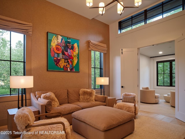 3220 N Teton Pines Dr, Wilson, WY 83014 - living area featuring a chandelier, healthy amount of natural light, and a high ceiling