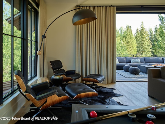 3220 N Teton Pines Dr, Wilson, WY 83014 - living area with wood finished floors and a view of trees