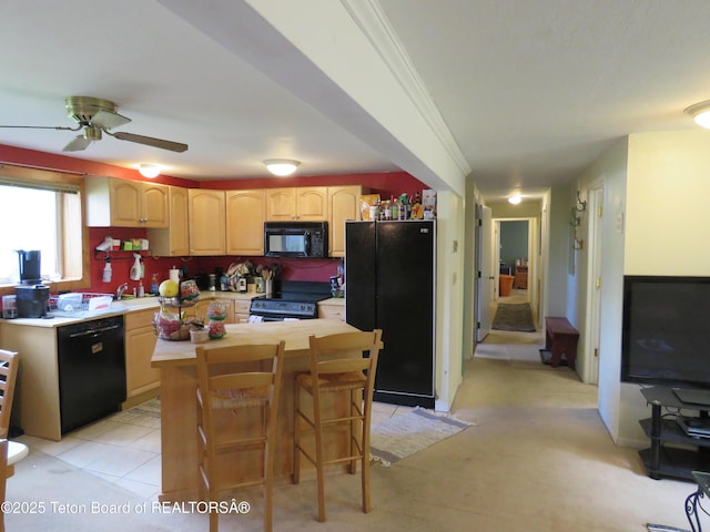 680 E Hall St, Jackson, WY 83001 - kitchen featuring black appliances, light brown cabinets, a ceiling fan, and a center island