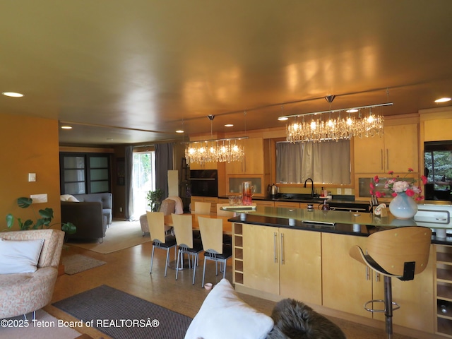 680 E Hall St, Jackson, WY 83001 - kitchen featuring a chandelier, dark countertops, light brown cabinets, open floor plan, and recessed lighting
