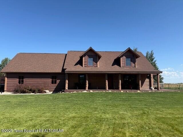 2160 Tomahawk Trl, Victor, ID 83455 - log cabin featuring a front lawn and covered porch